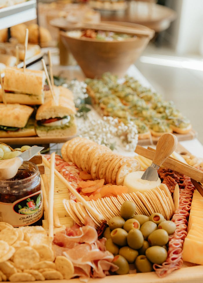 services-05 A delicious spread of assorted sandwiches, olives, and crackers creating a perfect party display.